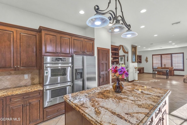 41 Sun Point Ln, El Paso, TX 79912 - kitchen with stainless steel appliances, light tile patterned floors, backsplash, light stone counters, and recessed lighting