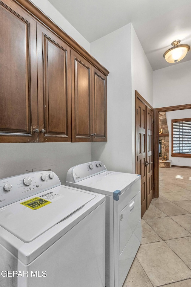 41 Sun Point Ln, El Paso, TX 79912 - laundry area with washer and clothes dryer, cabinet space, and light tile patterned floors