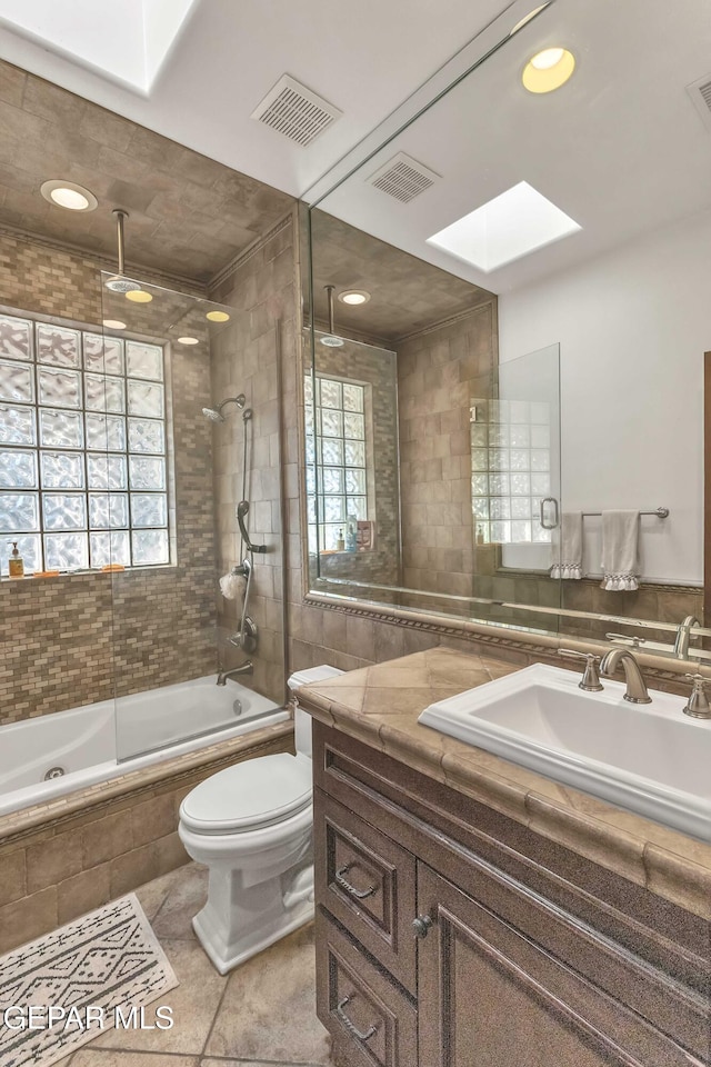 41 Sun Point Ln, El Paso, TX 79912 - bathroom with a skylight, healthy amount of natural light, a combined bath / shower with rainfall shower, vanity, and tile walls