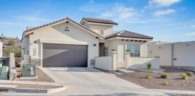 7424 Cimarron Gap Dr, El Paso, TX 79911 - mediterranean / spanish-style house featuring driveway, a garage, stucco siding, and a tile roof