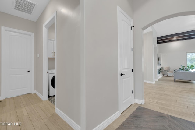 7424 Cimarron Gap Dr, El Paso, TX 79911 - hall with washer / dryer, arched walkways, and light wood-style flooring