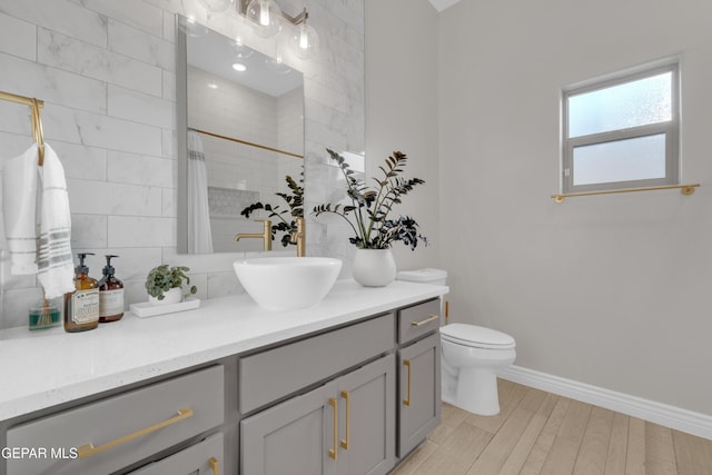 7424 Cimarron Gap Dr, El Paso, TX 79911 - full bathroom with vanity, tiled shower, backsplash, and wood finished floors
