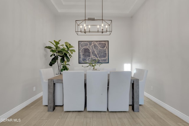 7424 Cimarron Gap Dr, El Paso, TX 79911 - dining room featuring a chandelier, a tray ceiling, and wood finished floors