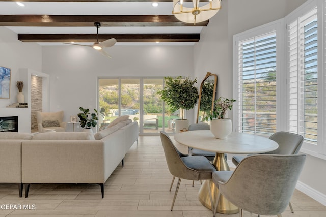 7424 Cimarron Gap Dr, El Paso, TX 79911 - living area with beamed ceiling, healthy amount of natural light, a glass covered fireplace, a towering ceiling, and a ceiling fan