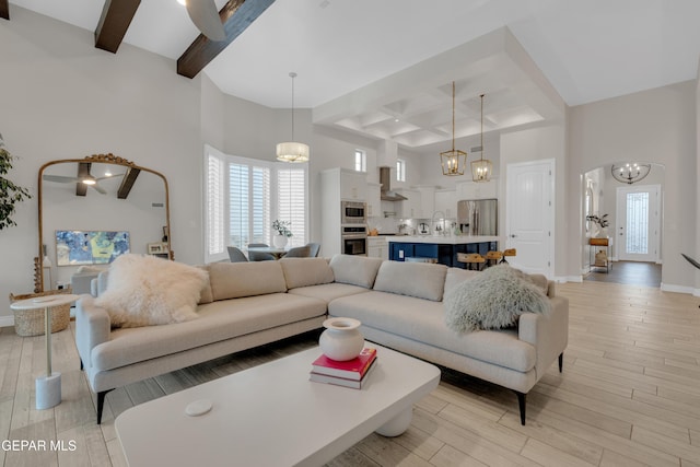 7424 Cimarron Gap Dr, El Paso, TX 79911 - living room featuring a chandelier, beam ceiling, light wood-style floors, a towering ceiling, and coffered ceiling