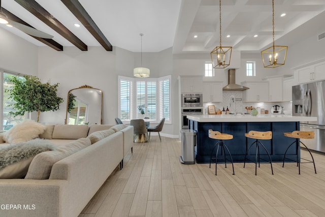 7424 Cimarron Gap Dr, El Paso, TX 79911 - kitchen featuring stainless steel appliances, open floor plan, beamed ceiling, light countertops, and a kitchen breakfast bar