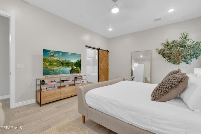 7424 Cimarron Gap Dr, El Paso, TX 79911 - bedroom featuring a barn door, wood finished floors, and recessed lighting