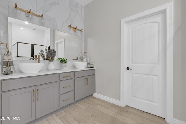 7424 Cimarron Gap Dr, El Paso, TX 79911 - full bath featuring double vanity, wood finished floors, and a tile shower