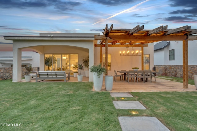 7424 Cimarron Gap Dr, El Paso, TX 79911 - back of property at dusk with an outdoor hangout area, stucco siding, a pergola, a yard, and a patio area