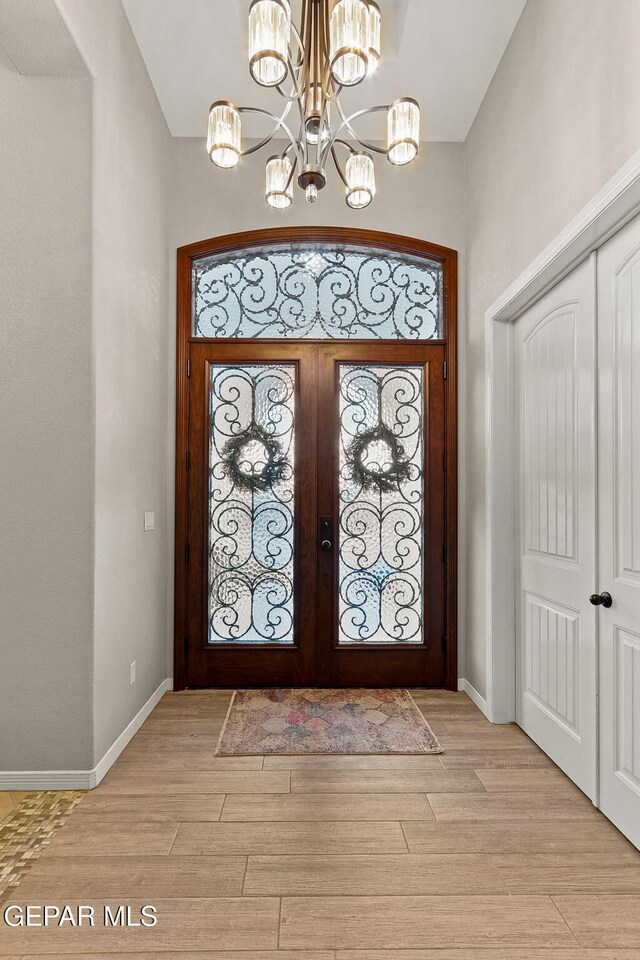 12289 Freshwater Dr, El Paso, TX 79928 - entrance foyer featuring a chandelier, french doors, and light wood-style floors