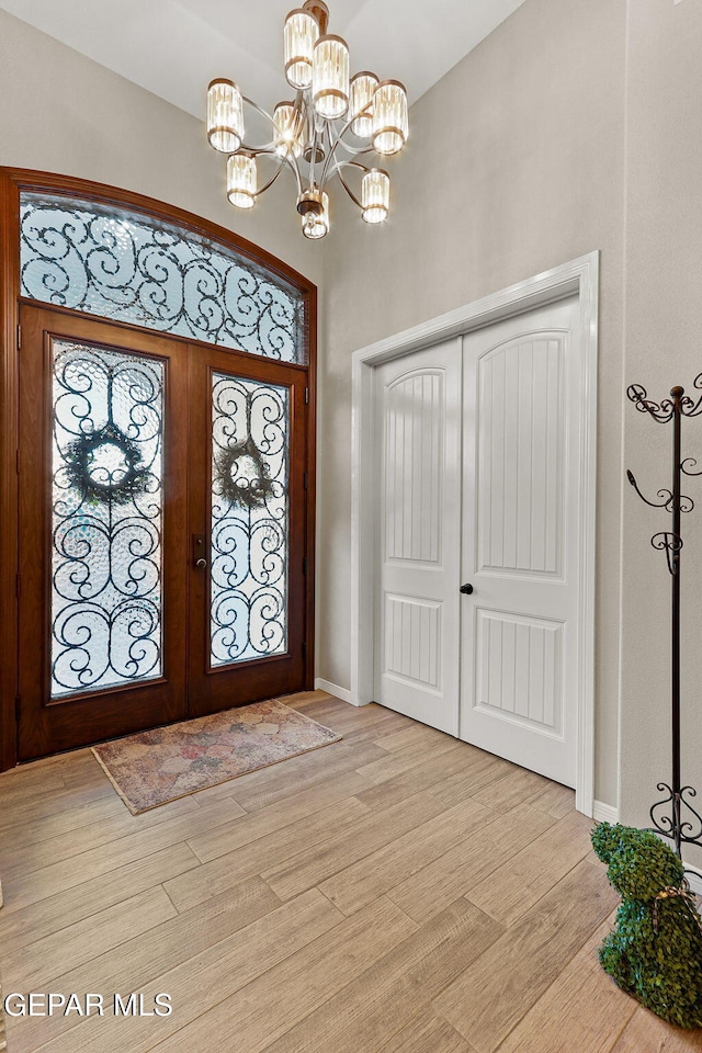 12289 Freshwater Dr, El Paso, TX 79928 - foyer entrance featuring light wood finished floors, french doors, and a chandelier