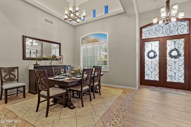12289 Freshwater Dr, El Paso, TX 79928 - dining space with a chandelier, light wood-type flooring, a high ceiling, and french doors
