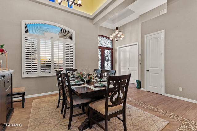 12289 Freshwater Dr, El Paso, TX 79928 - dining space featuring a chandelier, a towering ceiling, and light wood-type flooring