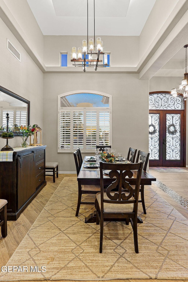 12289 Freshwater Dr, El Paso, TX 79928 - dining space featuring a chandelier, light wood-style flooring, french doors, and a high ceiling