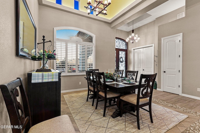 12289 Freshwater Dr, El Paso, TX 79928 - dining area with a chandelier, a high ceiling, and wood finished floors
