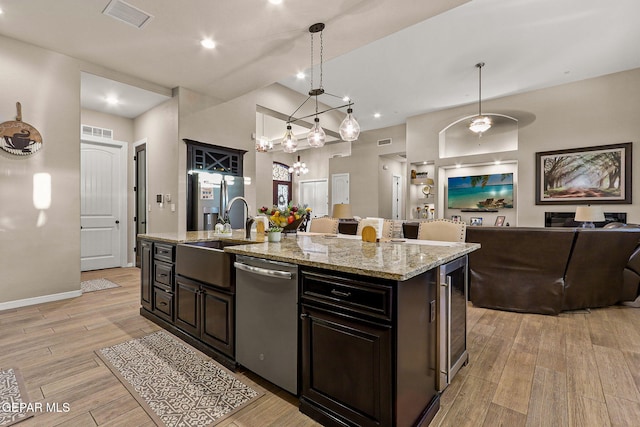 12289 Freshwater Dr, El Paso, TX 79928 - kitchen with dishwasher, open floor plan, beverage cooler, a center island with sink, and light wood-type flooring