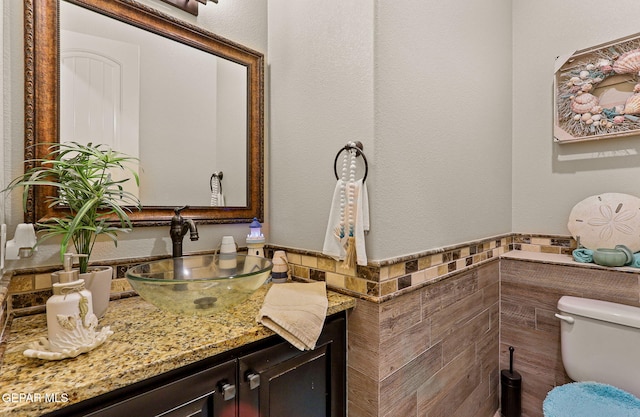 12289 Freshwater Dr, El Paso, TX 79928 - half bath with tile walls, vanity, and a wainscoted wall