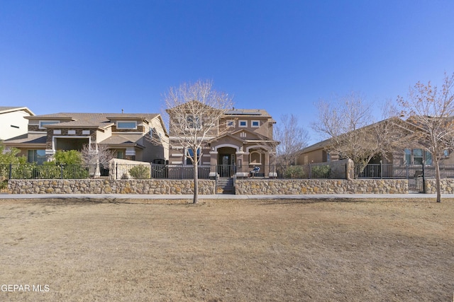 2057A Howard Jones, El Paso, TX 79938 - view of front of property featuring a fenced front yard, stucco siding, and solar panels