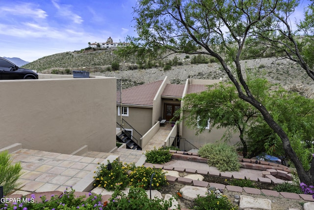 34 Kingery Dr, El Paso, TX 79902 - rear view of property with stucco siding and a tiled roof