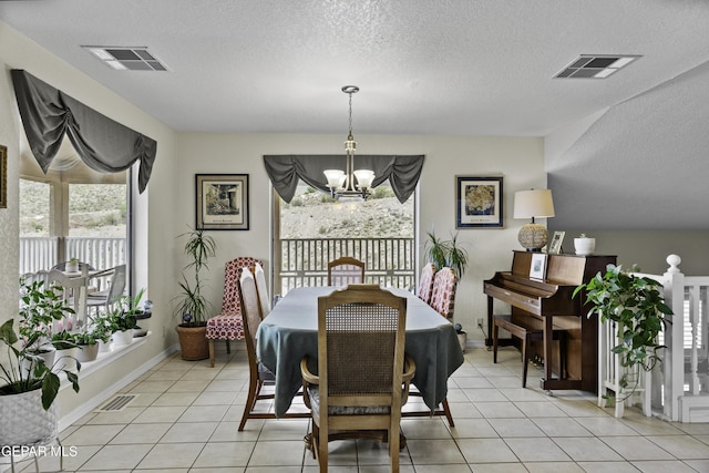 34 Kingery Dr, El Paso, TX 79902 - dining room with a chandelier, light tile patterned floors, and a textured ceiling