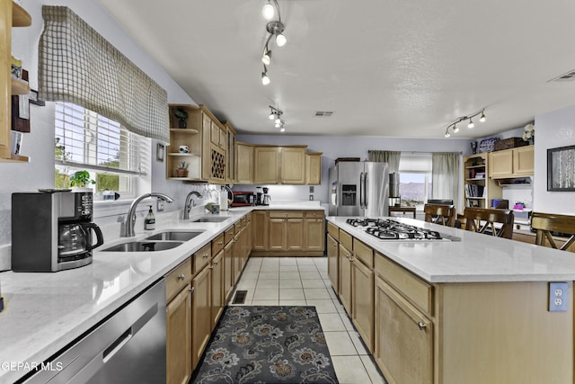 34 Kingery Dr, El Paso, TX 79902 - kitchen with stainless steel appliances, track lighting, open shelves, light tile patterned floors, and a center island
