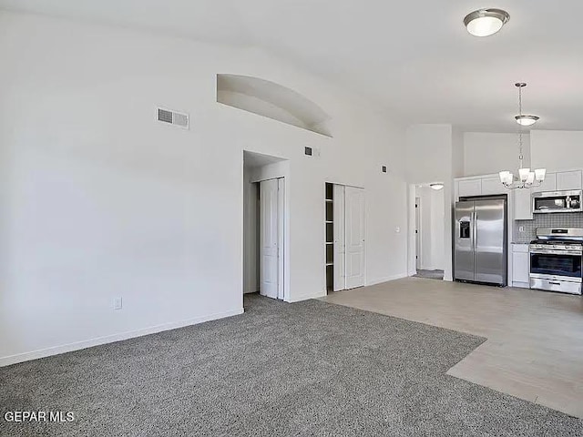 14309 Seth Payne Dr, El Paso, TX 79928 - unfurnished living room with a chandelier and high vaulted ceiling