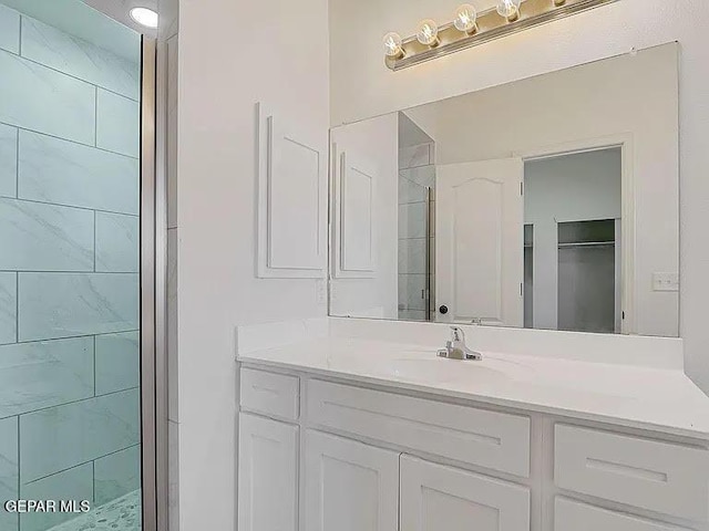 14309 Seth Payne Dr, El Paso, TX 79928 - bathroom with vanity, tiled shower, and a walk in closet