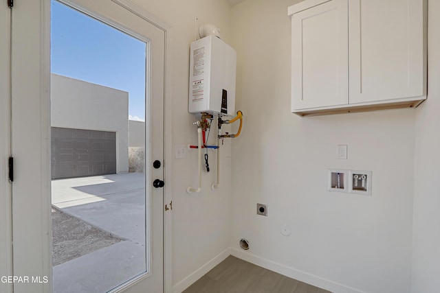 14309 Seth Payne Dr, El Paso, TX 79928 - laundry area with electric dryer hookup, cabinet space, tankless water heater, wood finished floors, and hookup for a washing machine