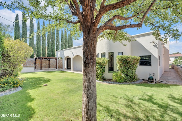 5833 Sundale Rd, El Paso, TX 79912 - view of front facade with stucco siding, a front yard, and a patio area