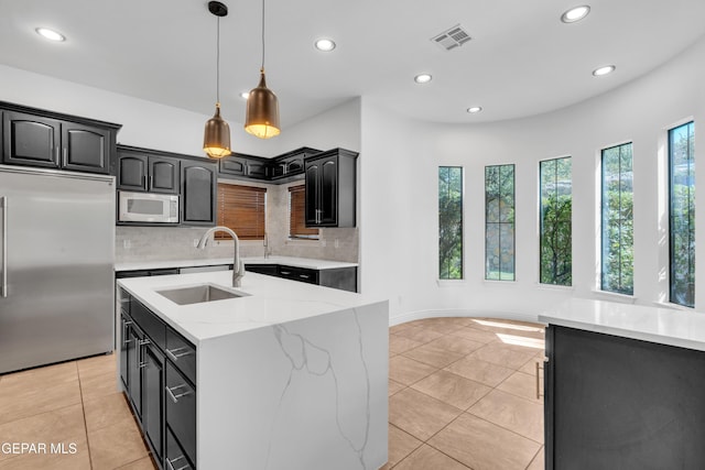5833 Sundale Rd, El Paso, TX 79912 - kitchen featuring built in refrigerator, plenty of natural light, white microwave, recessed lighting, and tasteful backsplash