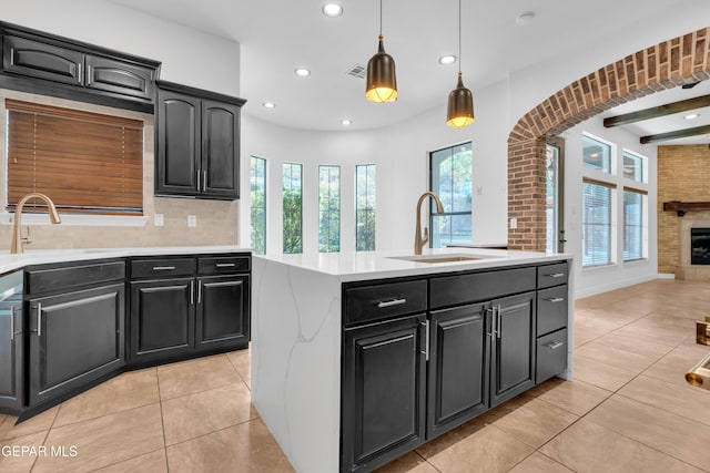 5833 Sundale Rd, El Paso, TX 79912 - kitchen with recessed lighting, light countertops, healthy amount of natural light, light tile patterned floors, and dark cabinets