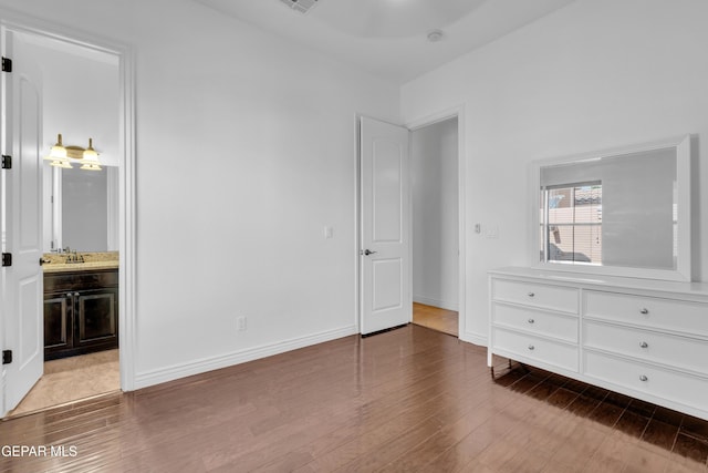 5833 Sundale Rd, El Paso, TX 79912 - unfurnished bedroom with wood finished floors and ensuite bath