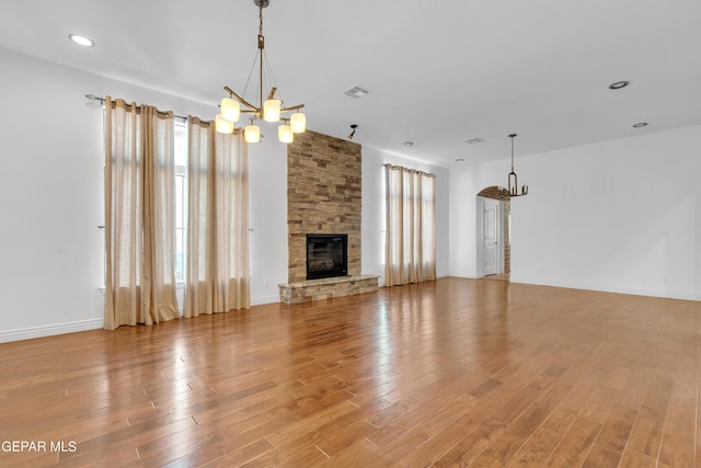 5833 Sundale Rd, El Paso, TX 79912 - unfurnished living room featuring a chandelier, light wood-style floors, a fireplace, and recessed lighting