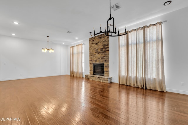 5833 Sundale Rd, El Paso, TX 79912 - unfurnished living room with a chandelier, recessed lighting, wood finished floors, and a fireplace