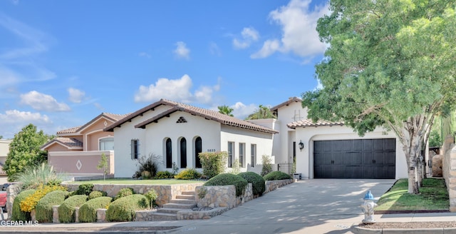 5833 Sundale Rd, El Paso, TX 79912 - mediterranean / spanish-style home with stucco siding, driveway, a tile roof, and an attached garage