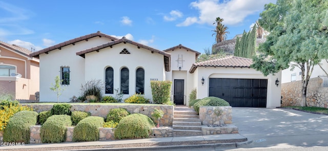 5833 Sundale Rd, El Paso, TX 79912 - mediterranean / spanish-style home with a tiled roof, concrete driveway, a garage, and stucco siding
