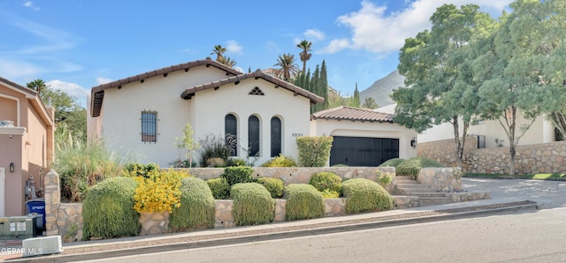 5833 Sundale Rd, El Paso, TX 79912 - mediterranean / spanish home with a tiled roof, stucco siding, and a garage
