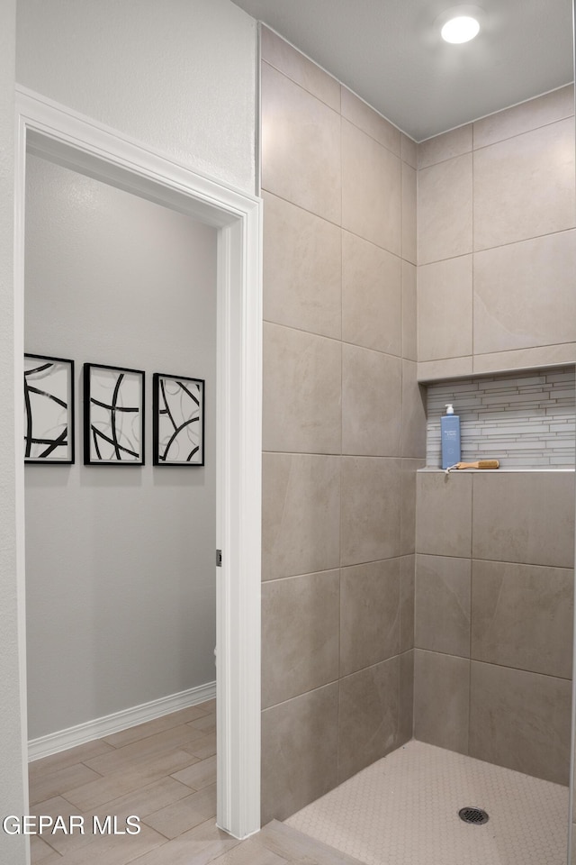 2204 Small Mountain Place, El Paso, TX 79911 - bathroom featuring baseboards and a tile shower
