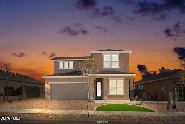 2225 Moon Loft Pl, El Paso, TX 79911 - view of front of property featuring stucco siding, concrete driveway, an attached garage, and stone siding