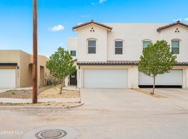 801 Hc Gilbert Minjares Dr Unit A, Socorro, TX 79927 - mediterranean / spanish-style house featuring a tile roof, driveway, a garage, and stucco siding