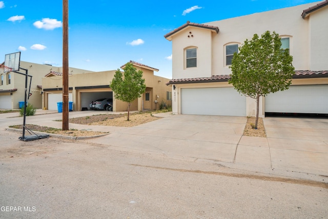 801 Hc Gilbert Minjares Dr Unit A, Socorro, TX 79927 - mediterranean / spanish home featuring a tile roof, stucco siding, concrete driveway, and a garage