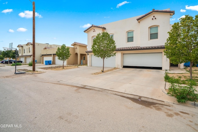 801 Hc Gilbert Minjares Dr Unit A, Socorro, TX 79927 - mediterranean / spanish house with an attached garage, a tile roof, stucco siding, and concrete driveway