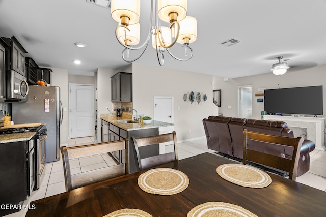 801 Hc Gilbert Minjares Dr Unit A, Socorro, TX 79927 - dining room with light tile patterned floors, ceiling fan, and a chandelier