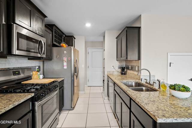 801 Hc Gilbert Minjares Dr Unit A, Socorro, TX 79927 - kitchen with stainless steel appliances, decorative backsplash, light tile patterned floors, light stone countertops, and a peninsula