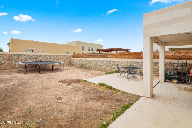 801 Hc Gilbert Minjares Dr Unit A, Socorro, TX 79927 - fenced backyard featuring a trampoline and a patio