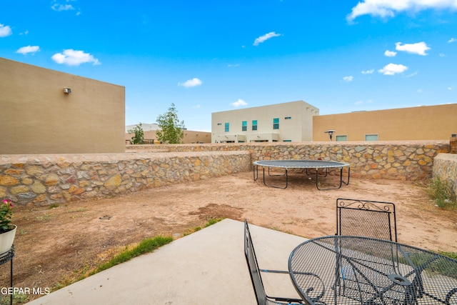 801 Hc Gilbert Minjares Dr Unit A, Socorro, TX 79927 - fenced backyard featuring a trampoline, a patio area, and outdoor dining space