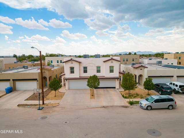 801 Hc Gilbert Minjares Dr Unit A, Socorro, TX 79927 - mediterranean / spanish home with stucco siding, concrete driveway, and a mountain view