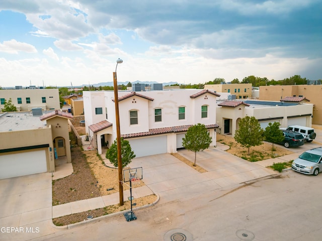801 Hc Gilbert Minjares Dr Unit A, Socorro, TX 79927 - mediterranean / spanish house with concrete driveway, stucco siding, a tiled roof, and a garage