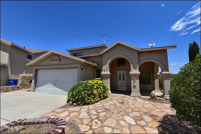 3517 Tierra Bahia Dr, El Paso, TX 79938 - view of front of home with driveway, an attached garage, and stucco siding