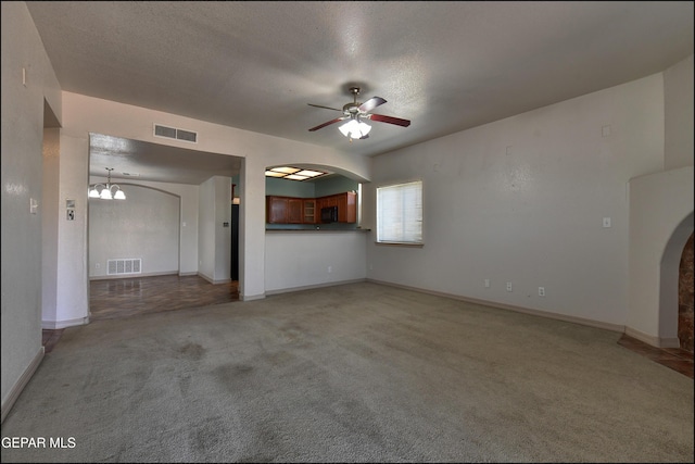 3517 Tierra Bahia Dr, El Paso, TX 79938 - unfurnished living room with arched walkways, ceiling fan, light colored carpet, a chandelier, and a textured ceiling